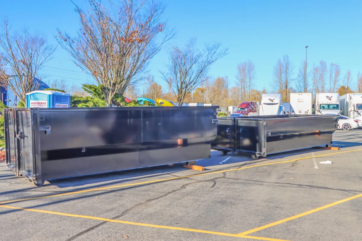 Professional dumpster rental service with roll-off container on residential driveway in Maquoketa